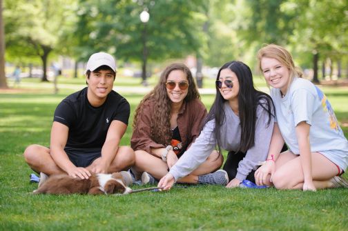 a group of students sit together on the quad