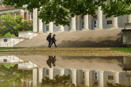 two students walk in front of gorgas library