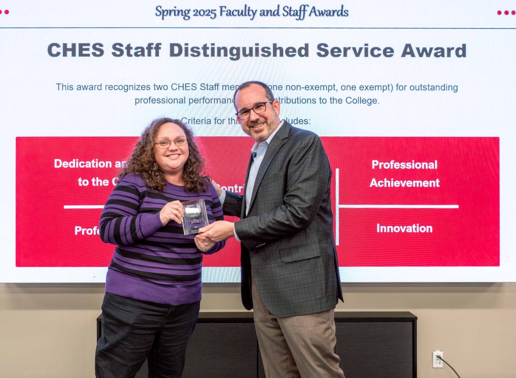 Martha Sears receives her award from the dean