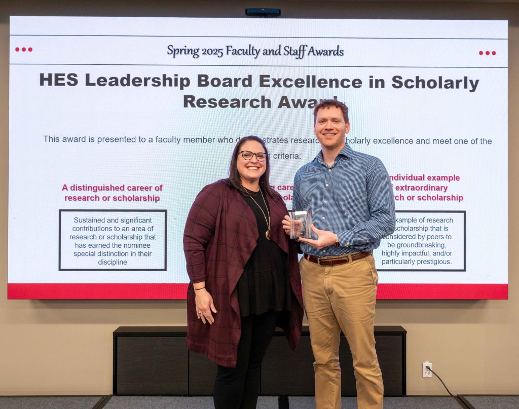Dr. Lizzie Elder presents Dr. Ryan Moran with his award