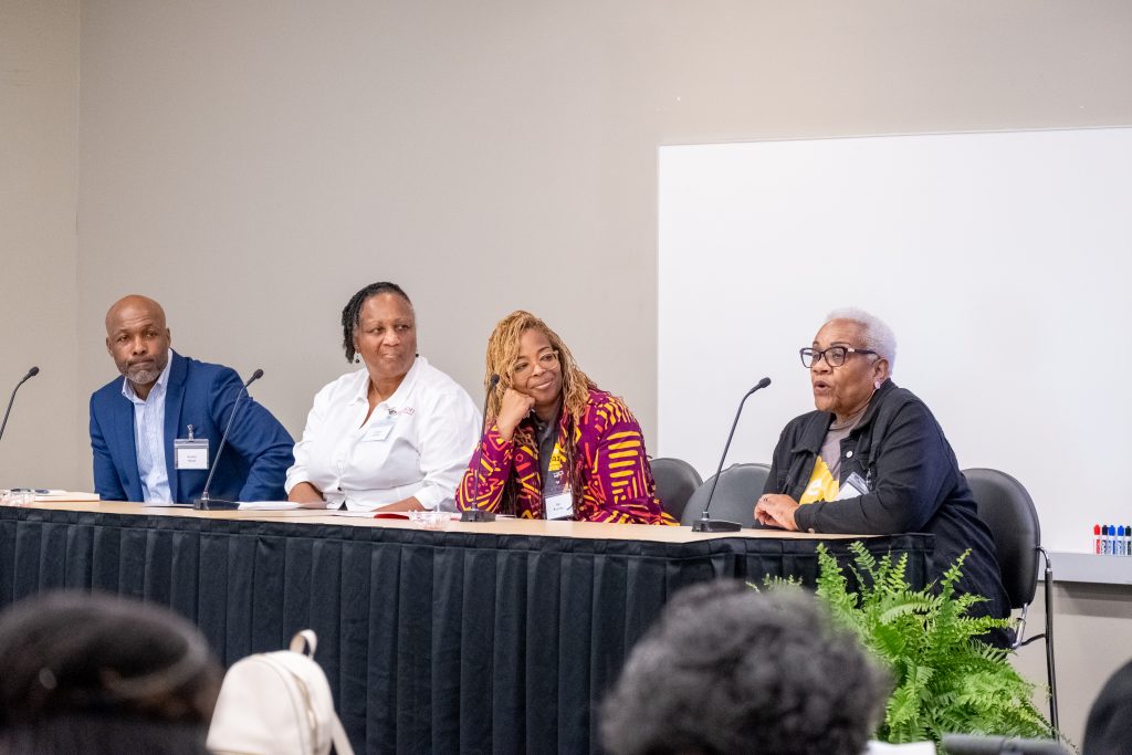 A panel at a table answering questions