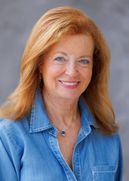 Beth Sherman member of Dean office in College of Human Environmental Sciences wearing a teal shirt.